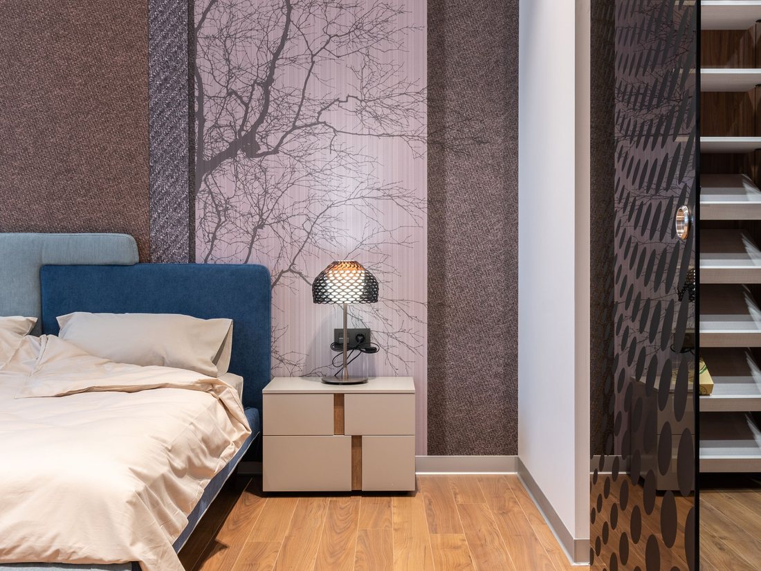Bedroom with a soft tree-branch wall mural
