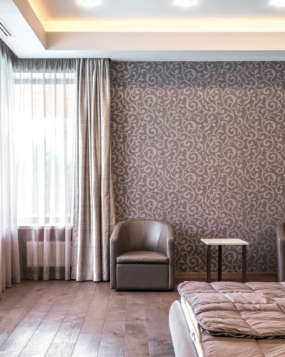 Serene bedroom with a warm taupe textured wallcovering