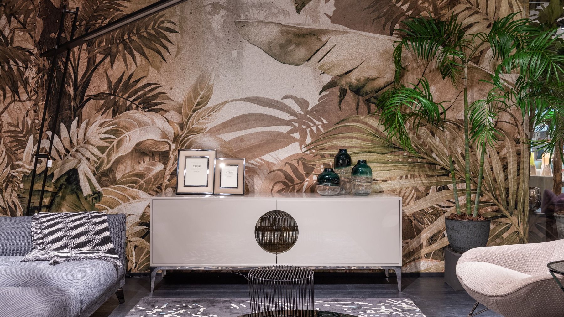 Warm living room with a botanical wall mural and natural light